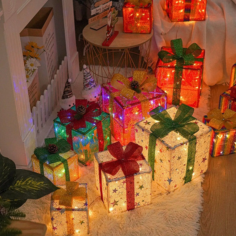 Decorative Christmas presents with lights on a carpeted floor.