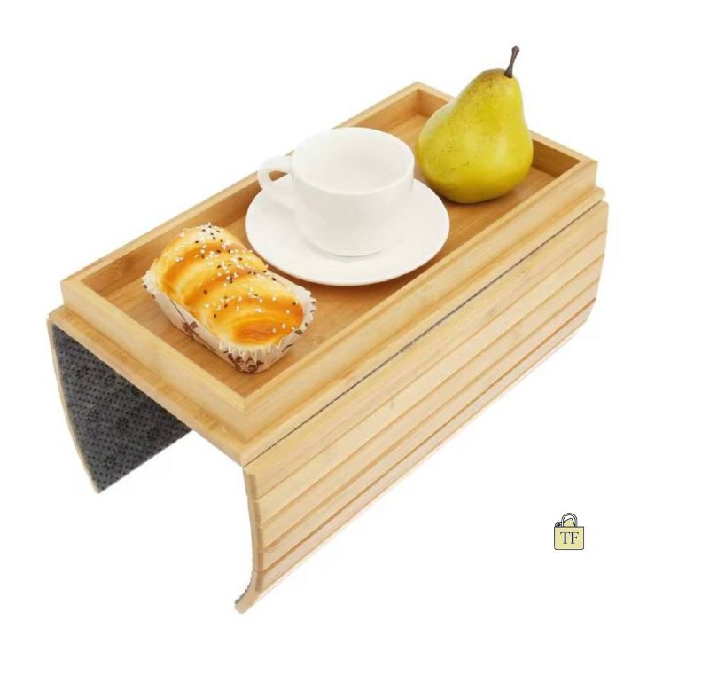 Wooden tray with a cup, saucer, and snacks on a white background