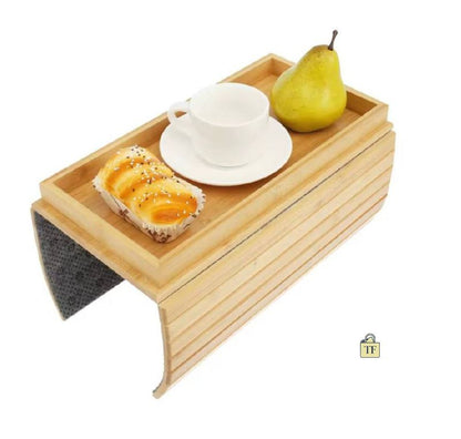 Wooden tray with a cup, saucer, and snacks on a white background