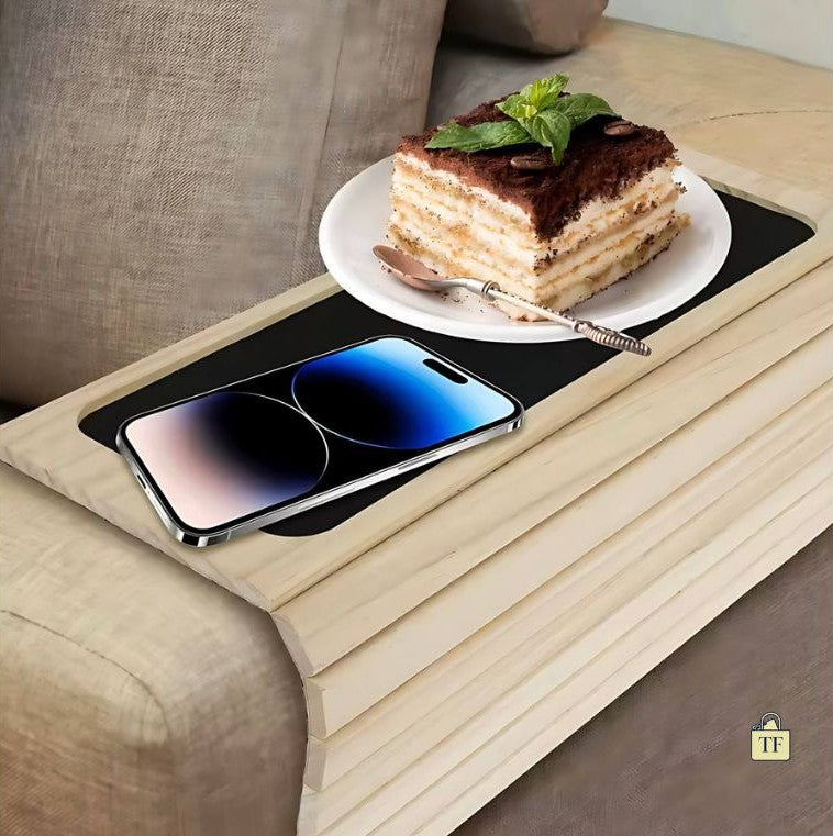 Phone,and dessert on a wooden tray with a sofa background