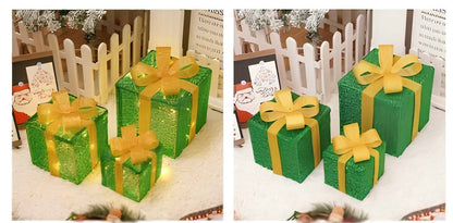 Green gift boxes with yellow ribbons on a white surface.